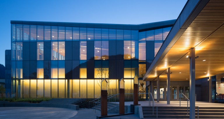 Multistory building with large windows and warm lighting