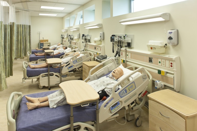 Medical training dummies in hospital beds