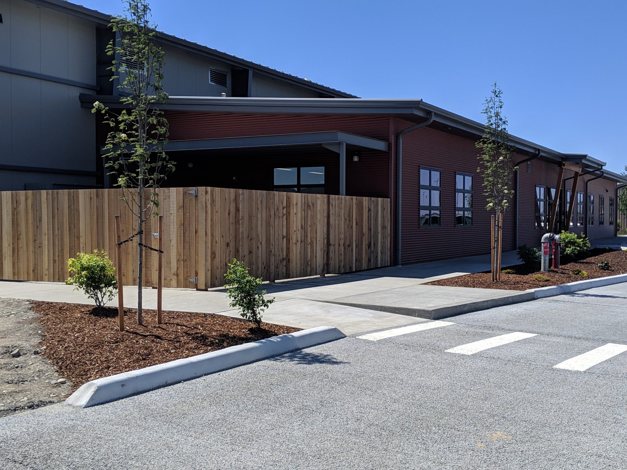 Exterior of one story building with red metal panelled walls