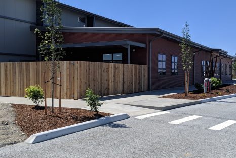 Exterior of one story building with red metal panelled walls