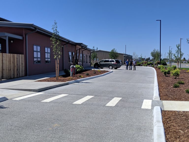 Three AMC employees standing outside of Chuckanut Bay Foods facility