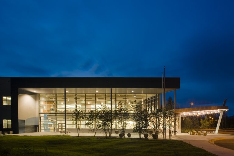 Brightly lit school visible through the windows in the evening