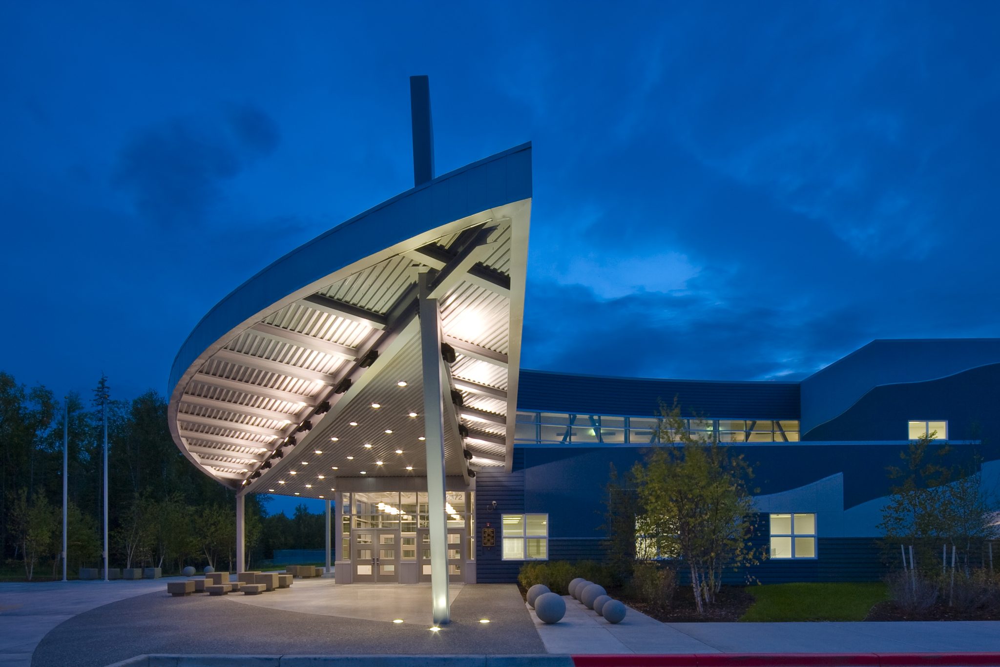 School entryway with decorative lighting along covering and floor