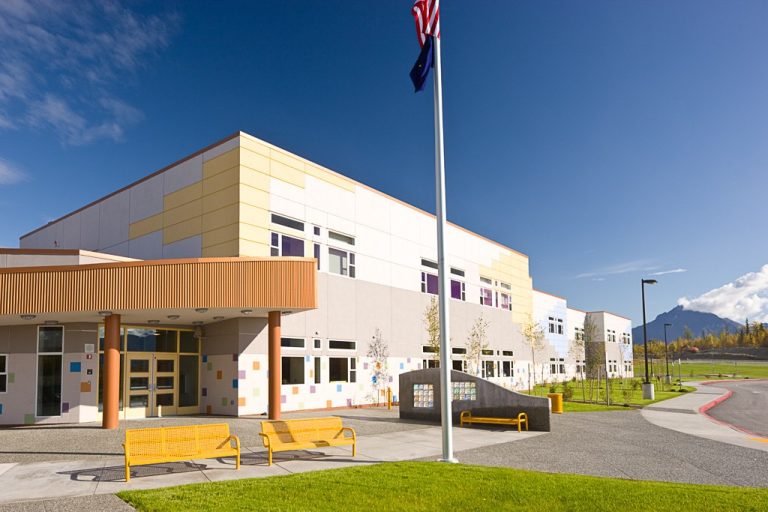 Multi-story school building with colorful tiles and patterns on exterior walls