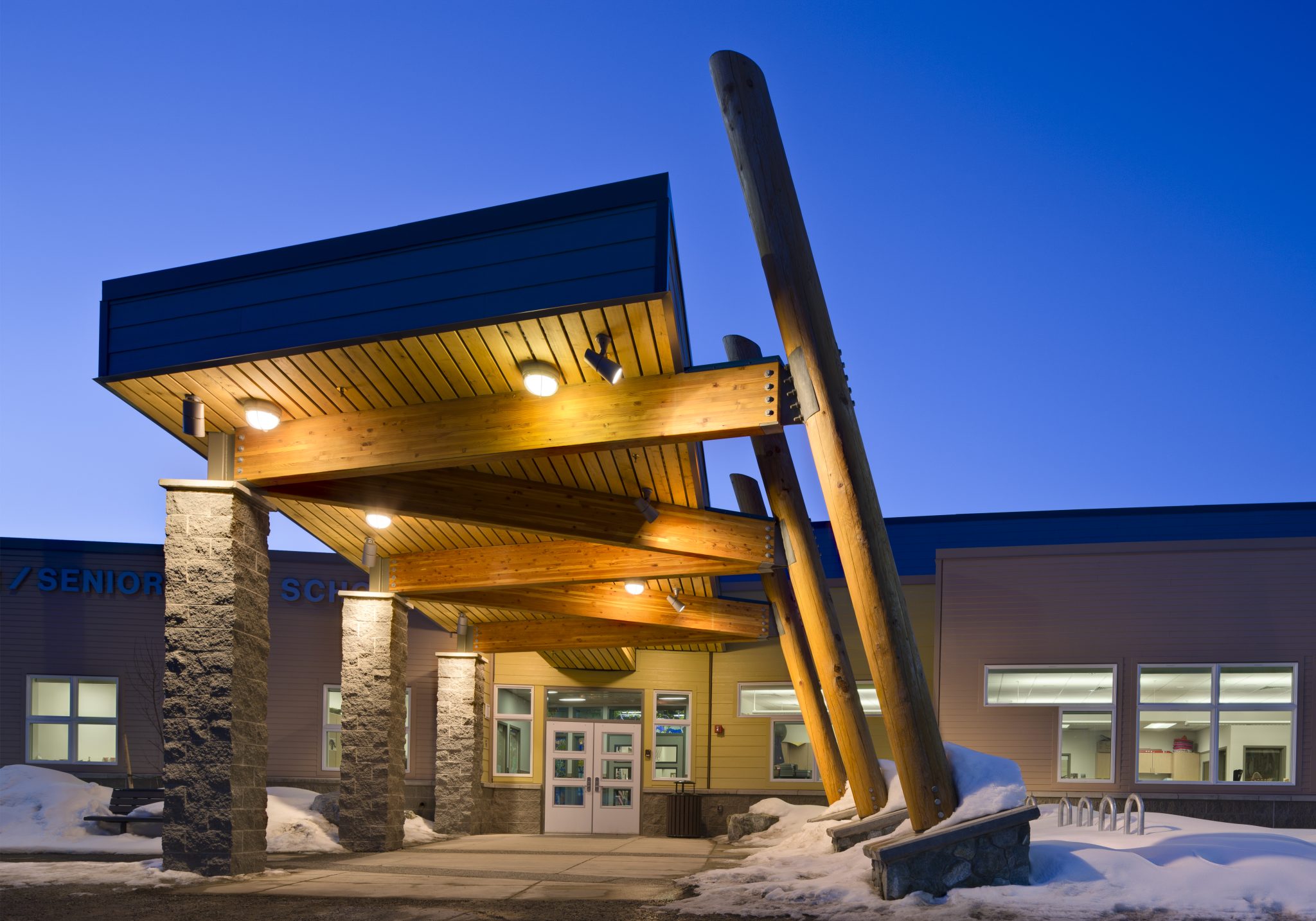 Decorative lighting in covered entryway to school