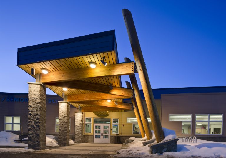 Decorative lighting in covered entryway to school
