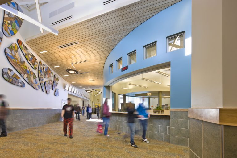 Decorative ceiling panels, lighting and vents in school hallway