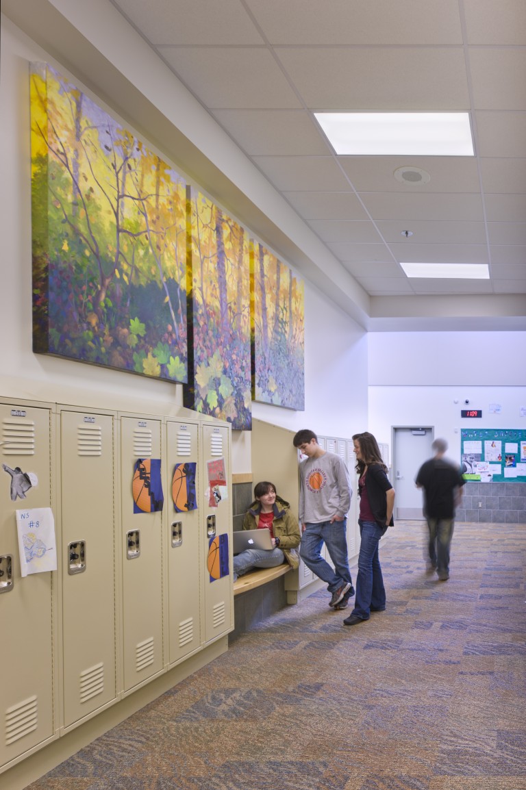 Students standing in brightly lit hallway