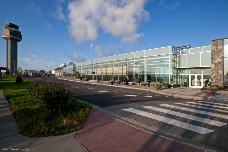 Road, air traffic control tower and exterior of airport
