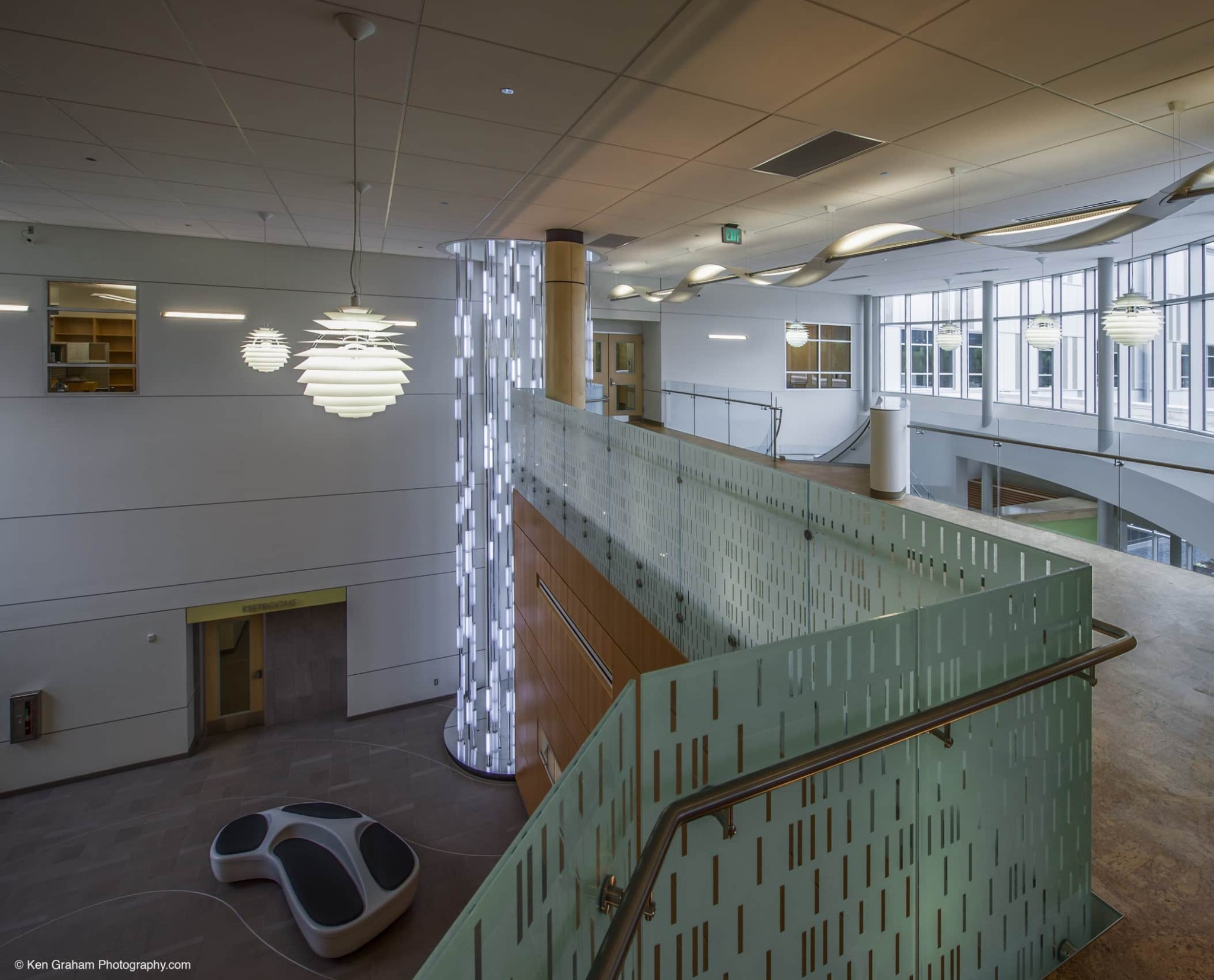 Decorative chandeliers and lighting in two story stairwell and entryway