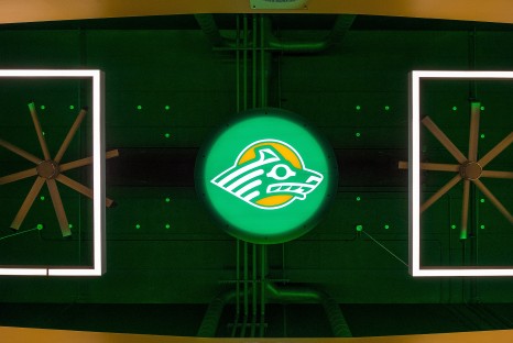 Decadent fans, lighting, and backlit University of Alaska Anchorage mascot logo above stadium