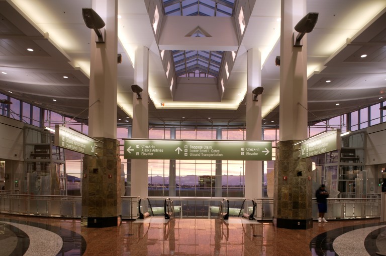 Brightly lit decorative lighting over baggage claim area