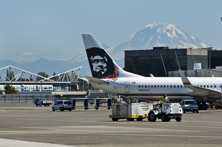 Airplanes and baggage handlers on tarmac