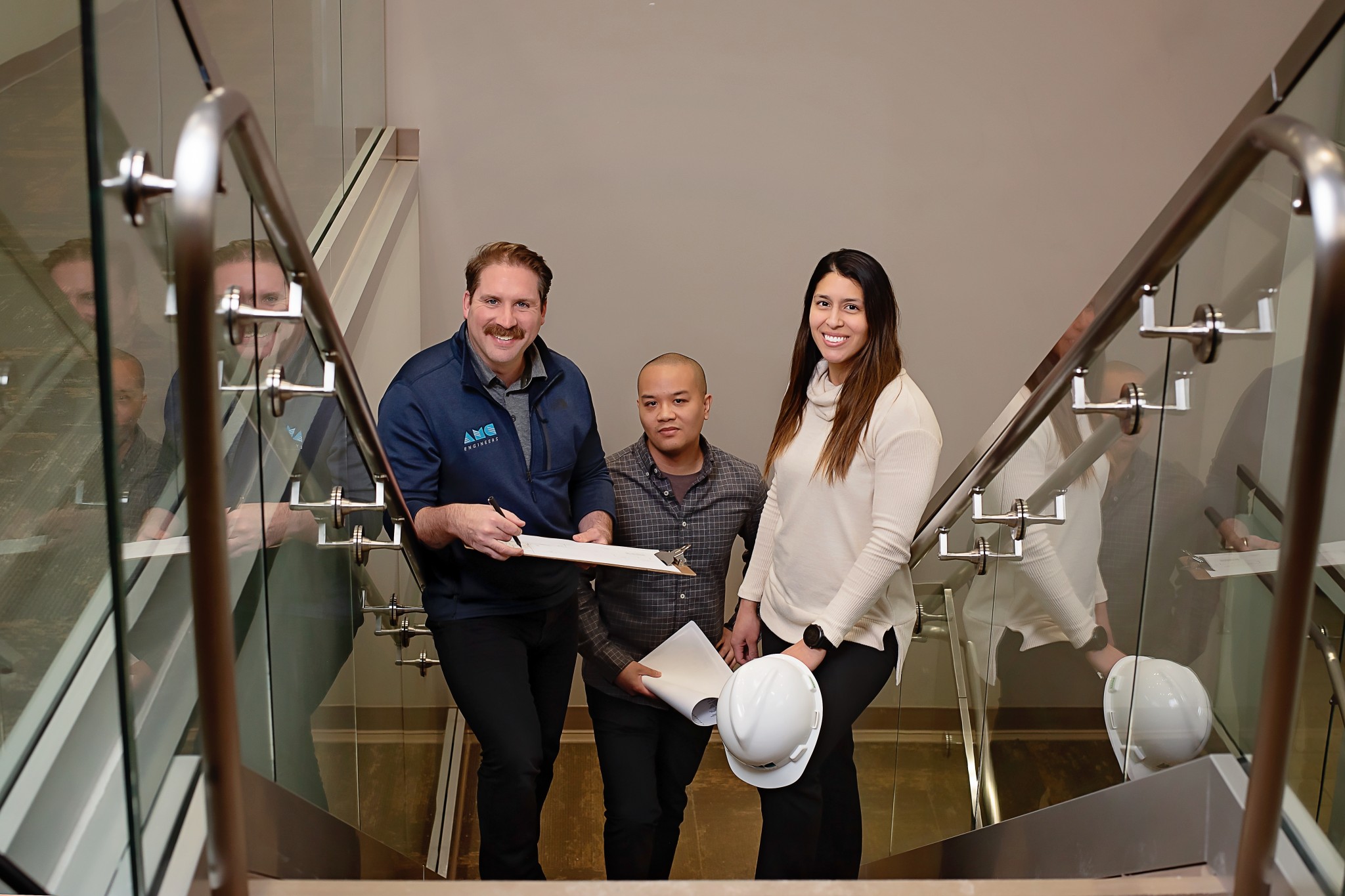 AMC employees posing together in stairwell