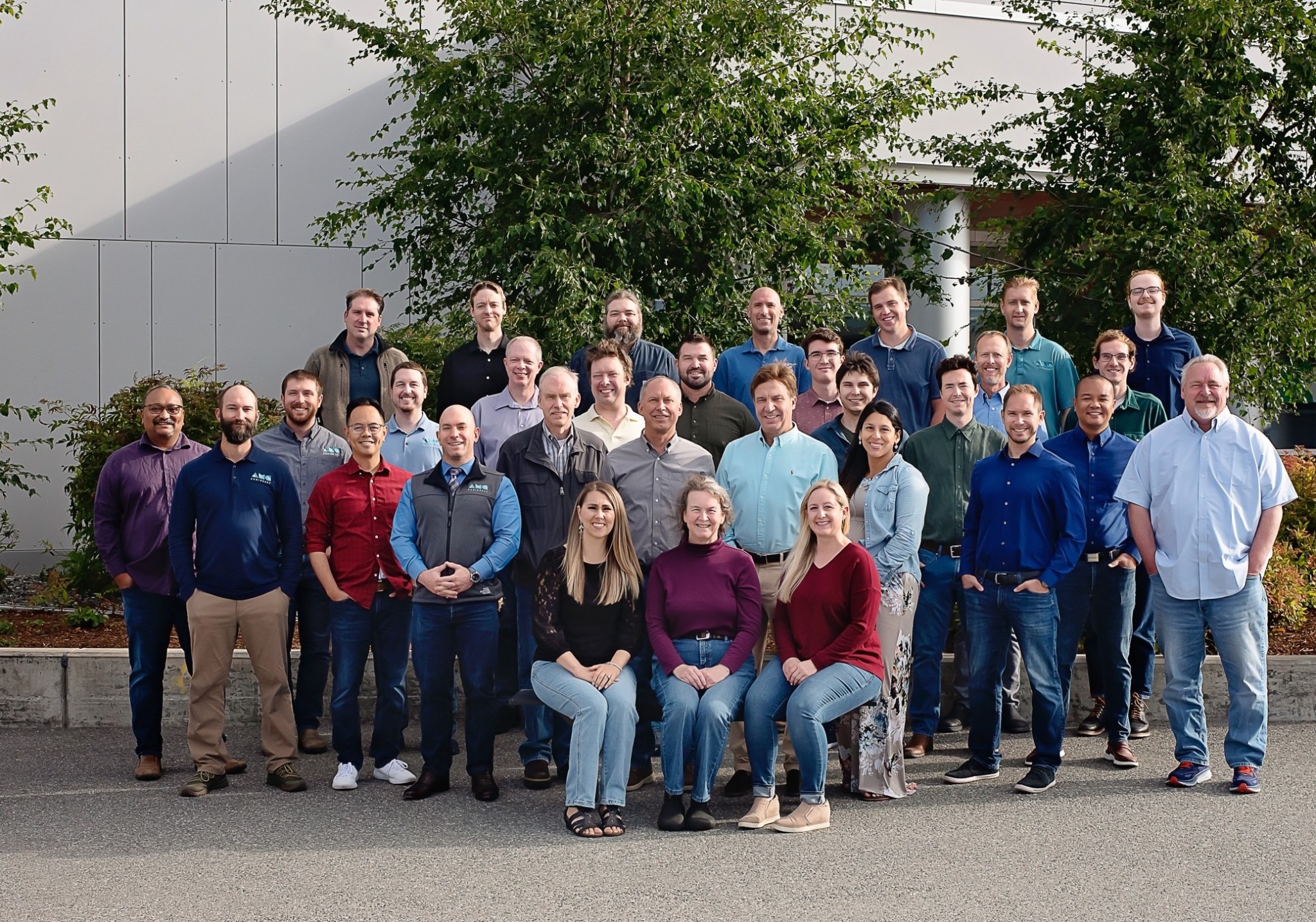 AMC team posing in front of building