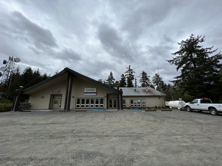 Front entrance of tan wood slab buildling