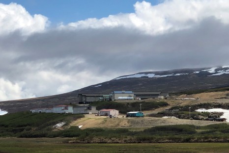 Buildings scattered in distance across snowy mountains