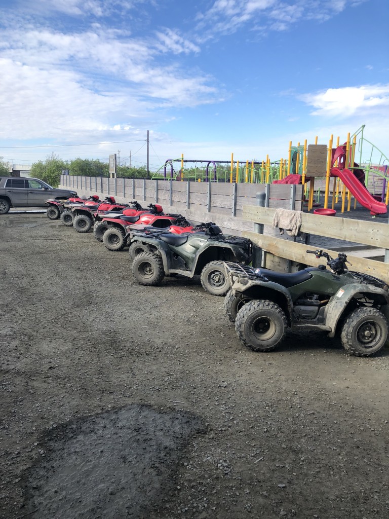 Multiple ATV parked outside of school playground