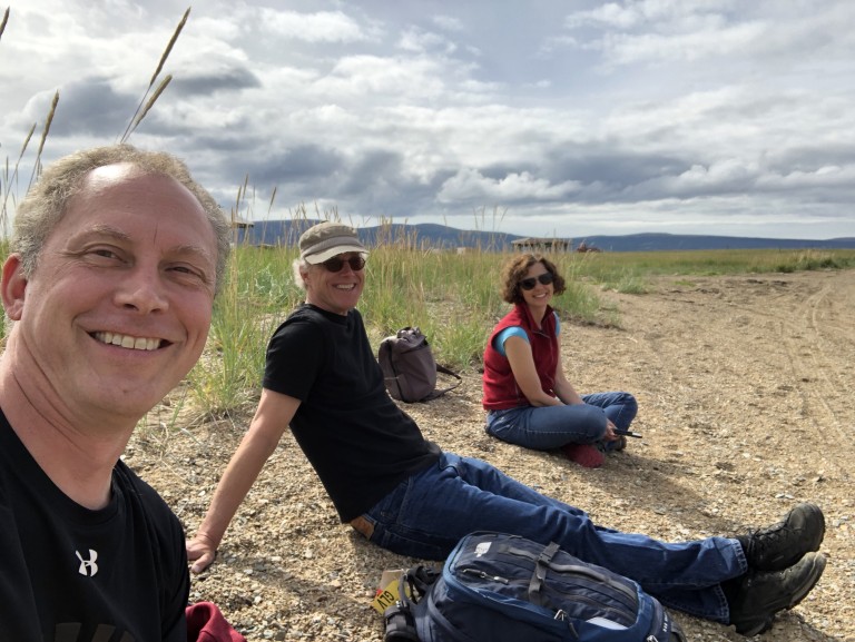 Group of people sitting on rocky coast