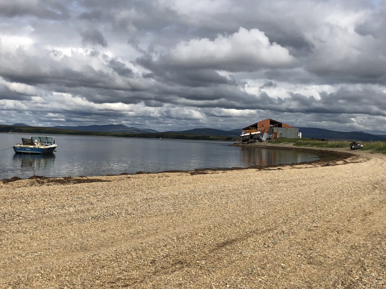 Worn down metal building along coast