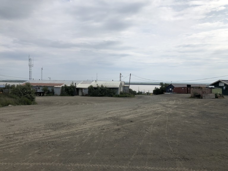 Buildings, power lines and storage containers along coast