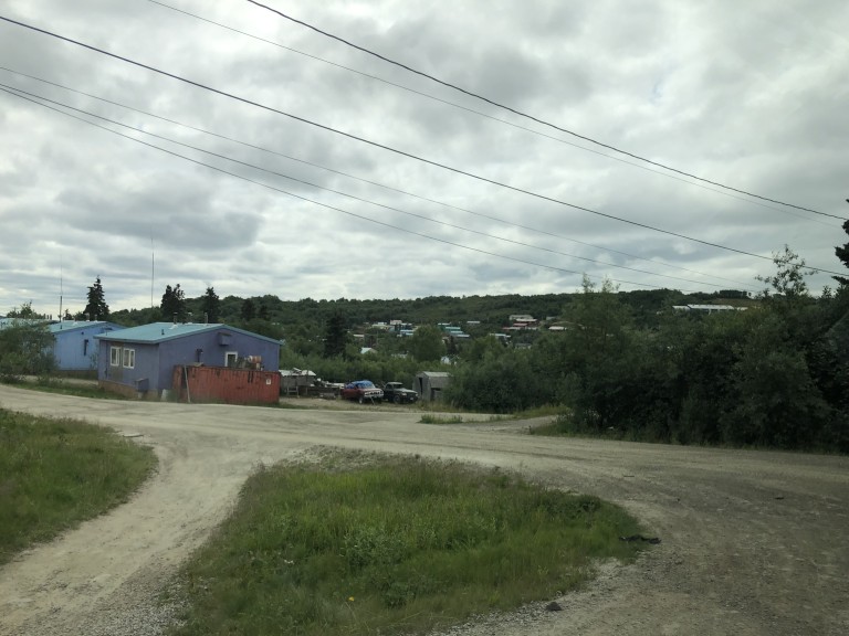 Group of buildings in the distance in wooded mountains