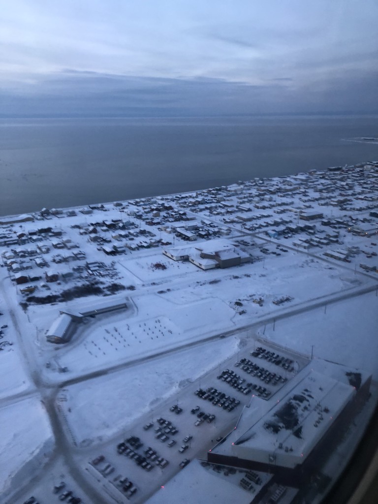 Birds eye view of town along coast in heavy snow