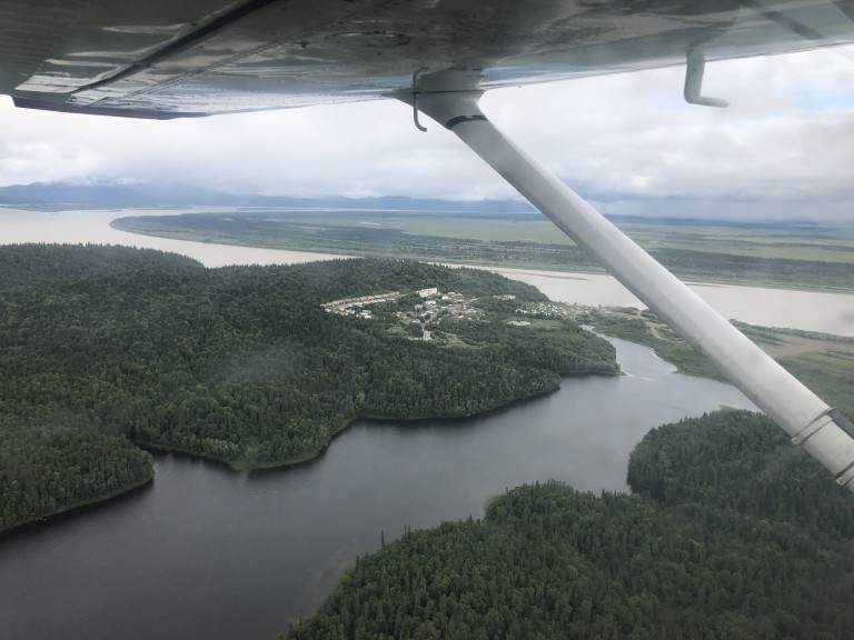 Aerial view of group of buildings and wooded areas along waterways