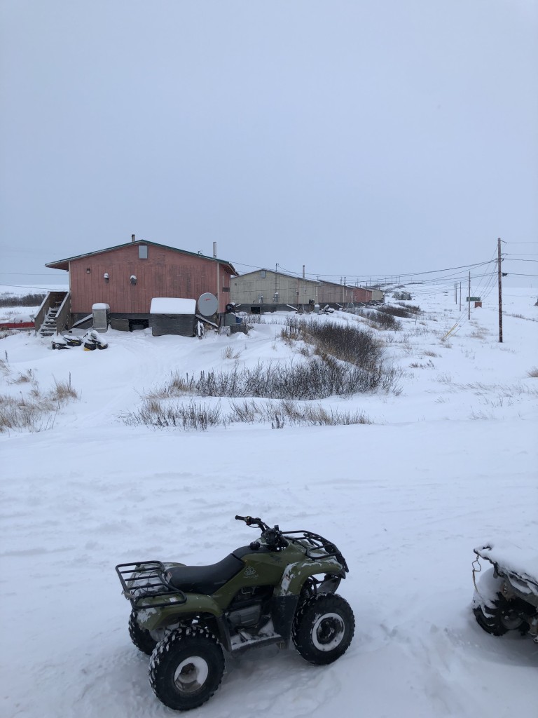 ATV and wood slab buildings in heavy snow