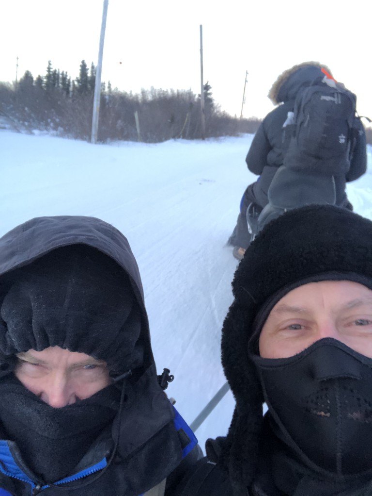 People wearing heavy coats in snowy terrain