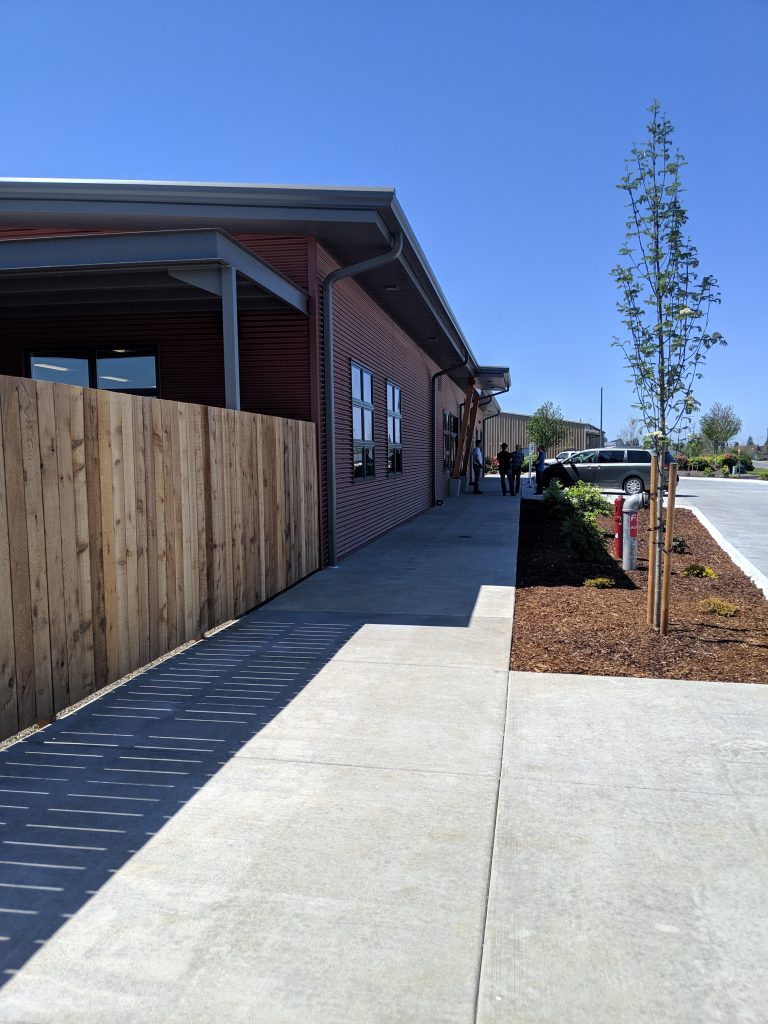 Three AMC employees standing and talking outside of Chuckanut Bay Foods facility