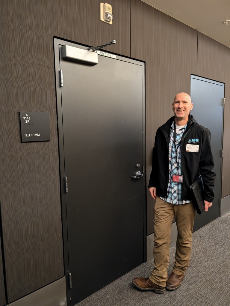 AMC employee outside telecomm room
