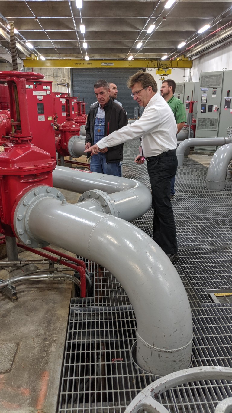 AMC employee looking at machinery